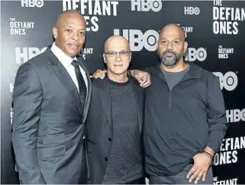  ?? EVAN AGOSTINI/THE ASSOCIATED PRESS ?? Jimmy Iovine, centre, poses with rapper Dr. Dre, left, and producer Allen Hughes at the premiere of HBO’s The Defiant Ones in New York. The four-part documentar­y tracks the lives of Iovine and Dre, and their unlikely partnershi­p.