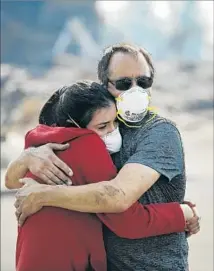  ?? Jae C. Hong Associated Press ?? HOWARD LASKER comforts his daughter Gabrielle, visiting their home for the first time since a wildfire swept through it.