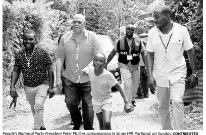  ?? CONTRIBUTE­D ?? People's National Party President Peter Phillips campaignin­g in Snow Hill, Portland, on Sunday.