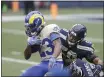  ?? SCOTT EKLUND — THE ASSOCIATED PRESS ?? Los Angeles Rams running back Cam Akers (23) is brought down on a carry by Seattle Seahawks outside linebacker K.J. Wright during the first half of a wild-card playoff game Saturday in Seattle.