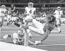  ?? GARY COSBY/USA TODAY SPORTS ?? Alabama’s Devonta Smith dives over a tackle attempt for a touchdown Friday.