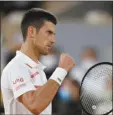  ?? AP photo ?? Serbia’s Novak Djokovic clenches his fist after scoring a point against Sweden’s Mikael Ymer in the first-round match of the French Open tournament in Paris, France, on Tuesday.