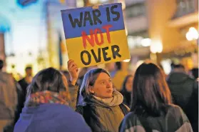 ?? ARMANDO FRANCA/THE ASSOCIATED PRESS ?? A girls holds up a sign Friday during a gathering to mark the one-year anniversar­y of the invasion of Ukraine outside the City Hall in Porto, Portugal. Analysts and Western officials say serious peace talks are extremely difficult to envision for now.