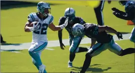  ?? BRIAN BLANCO — THE ASSOCIATED PRESS ?? Carolina Panthers running back Christian McCaffrey scores Sunday ahead of Raiders safety Johnathan Abram.