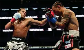  ?? Photograph: Jeff Chiu/AP ?? Devin Haney, left, lands a punch to Regis Prograis' head on Saturday during their WBC super lightweigh­t title fight in San Francisco.