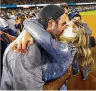  ?? Karen Warren / Houston Chronicle ?? Verlander (35) plants on a smooch on Upton after the Astros’ World Series win at Dodger Stadium.