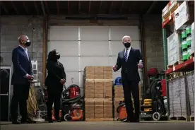  ?? CAROLYN KASTER — THE ASSOCIATED PRESS ?? President Joe Biden speaks with owners Kristin Smith and James Smith as he visits Smith Flooring in Chester, Pa., on Tuesday.