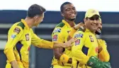  ?? CSK ?? Chennai Super Kings captain M. S. Dhoni shares a light moment with his team during an IPL game against Kolkata Knight Riders on Wednesday. —