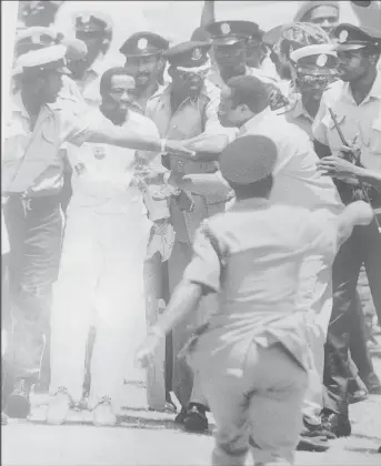  ?? ?? Laramania! Brian Lara is protected by a cordon of Antiguan policemen moments after he passed Sir Garry Sobers’ Test record of 365 (Source: Red Stripe Caribbean Cricket Quarterly Volume 4 Number 3, July/September, 1994)