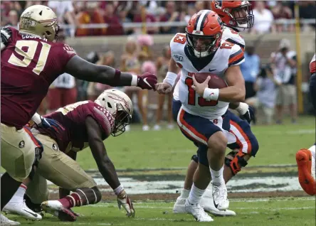  ?? STEVE CANNON - THE ASSOCIATED PRESS ?? Syracuse’s Tommy DeVito, right, tries to run around Florida State’s Robert Cooper during the first quarter of an NCAA college football game, Saturday, Oct. 26, 2019, in Tallahasse­e Fla.