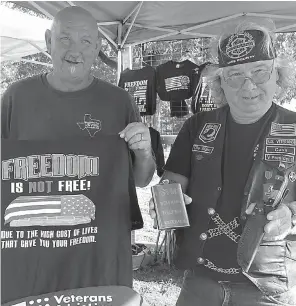  ?? Staff photos by Neil Abeles ?? The signs of this organizati­on are clear. This is the U.S. Veterans Motorcycle Club of Cass County in Linden recently. Notice the AR-15 rifle, on the table in front, which is being raffled. Members of the U.S. Veterans Motorcycle Club of Cass County like to have fun as they ride, then stop to set up a tent to host an auction, sell vegetables or pass out important, informativ­e literature. They are into supporting others, especially other veterans.