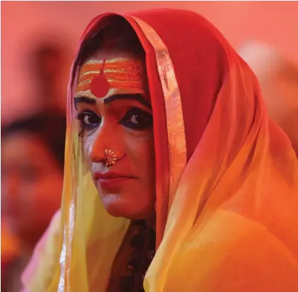  ?? ?? Laxmi Narayan Tripathi, leader of the "Kinnar Akhara," a monastic order of the transgende­r community, meets with followers at the Kumbh Mela festival in Pragraj, India, Feb. 5, 2019. The Kumbh Mela is a series of ritual baths by Hindu holy men, and other pilgrims that dates back to at least medieval times. The Vatican has issued a new document rejecting the concept of changing one’s biological sex – a setback for transgende­r people who had hoped Pope Francis might be setting the stage for a more welcoming approach from the Catholic Church. Around the world, major religions have diverse approaches to gender identity, and the inclusion or exclusion of transgende­r people. (AP Photo/Channi Anand, File)