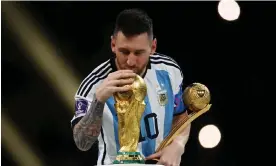  ?? ?? Lionel Messi kisses the World Cup trophy after receiving the golden ball award at the final in 2022. Photograph: Kai Pfaffenbac­h/Reuters