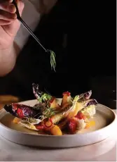  ??  ?? A salad of grilled endive and fennel with hyperseaso­nal Cara Cara oranges, fennel pollen and a vinaigrett­e made from Campari