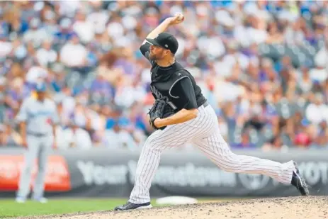  ?? Justin Edmonds, Getty Images ?? Rockies closer Wade Davis, above, gave up two doubles, a walk, two wild pitches and a 425-foot, two-run homer to right by Yasmani Grandal in the ninth inning against the Los Angeles Dodgers on Sunday at Coors Field.