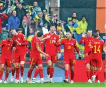  ?? ?? Wales players celebrate after taking the lead against Ukraine