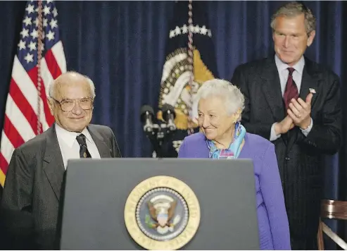 ?? TIM SLOAN / AFP / GETTY IMAGES ?? Then-U.S. president George W. Bush, right, honours economist Milton Friedman, left, and wife Rose Friedman in 2002.