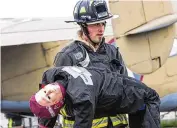  ?? U.S. AIR FORCE PHOTO/JAIMA FOGG ?? A firefighte­r from the 788th Civil Engineer Squadron carries a dummy “victim” to safety on May 5 during a mass-casualty exercise at Wright-Patterson Air Force Base.