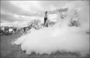  ?? AP/The Berkshire Eagle/STEPHANIE ZOLLSHAN ?? Harry Park of the Berkshire Museum in Pittsfield, Mass., creates a “thunder cloud” by pouring boiling water into a bucket of liquid nitrogen as part of March for Science festivitie­s in Pittsfield.