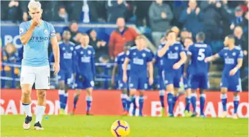  ??  ?? Manchester City’s Sergio Aguero (left) reacts as Leicester players celebrate scoring their second goal during the English Premier League match at King Power Stadium in Leicester, central England. — AFP Photo