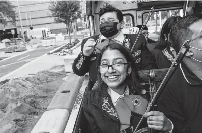  ?? Photos by Jon Shapley / Staff photograph­er ?? Marisa Salinas, 16, front, and Zayden Longoria, 14, laugh as they ride in an open-air school bus as part of a local news show Friday in downtown Houston.