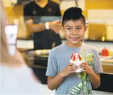  ??  ?? Xavi Perales, 9, holds a Strawberry Nana.