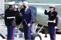  ?? The Associated Press ?? President Joe Biden returns a salute with a Marine Corps honor guard as he disembarks Marine One before boarding Air Force One on Friday at Andrews Air Force Base, Md.