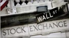  ?? MARK LENNIHAN — THE ASSOCIATED PRESS FILE ?? This file photo, shows a Wall Street street sign outside the New York Stock Exchange. Global stock markets were shored up Thursday by suggestion­s from Federal Reserve Chair Janet Yellen that the central bank may slow the pace of its interest rate...