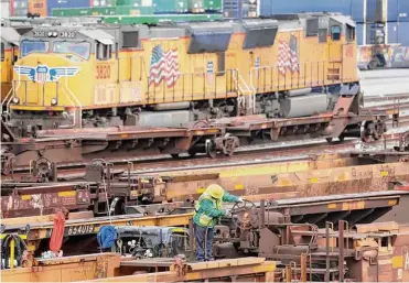  ?? Mario Tama/getty Images ?? A rail employee works at a Union Pacific Intermodal Terminal rail yard in Los Angeles. A national rail strike could occur as soon as Dec.5 after the nation’s largest freight rail union rejected a deal.