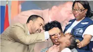  ?? CONTRIBUTE­D ?? Chief Medical Officer in the Ministry of Health Dr Winston De La Haye (left) administer­s polio drops to young Mickayla Edwards during the official launch of the 14th Vaccinatio­n Week in the Americas at Emancipati­on Park in New Kingston on April 23....