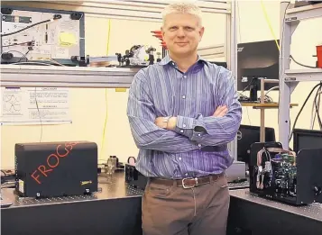  ?? COURTESY OF MESA PHOTONICS ?? Mesa Photonics founder and CEO Daniel Kane with the company’s ultra-fast laser measuring system, which the company developed with about $10 million in SBIR assistance since 2008.