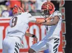  ?? SAM GREENE ?? Cincinnati QB Joe Burrow (9) celebrates with wide receiver Ja’marr Chase (1) after they connected for Chase’s career-first TD.