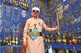  ?? Arshad Ali/Gulf News ?? ■ Qasim Mohammad Musaed Saeed surrounded by traditiona­l daggers and other handicraft­s at his stall in the Yemen pavilion.