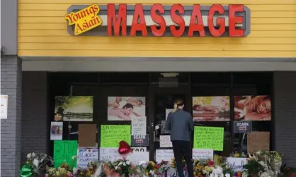  ?? Photograph: Tami Chappell/UPI/Rex/Shuttersto­ck ?? A person stands in front of a makeshift memorial outside Youngs Asian Massage in Acworth, Georgia, on 19 March.