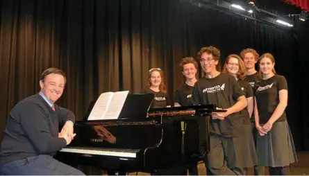  ?? Photo: Sean White ?? PITCH PERFECT: Downlands College arts curriculum leader Shane Tooley takes members of Gryphonix (from left) Eileen Scott, Josh Bartlett, Solomon Elisaia-Mamea, Clementine Tully, Jed Campbell and Katie McDougall through rehearsals.