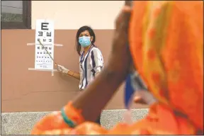  ?? (AP/Bikram Rai) ?? A patient gets her eye checked during her follow-up exam after her cataract surgery at an eye camp in Lumbini.