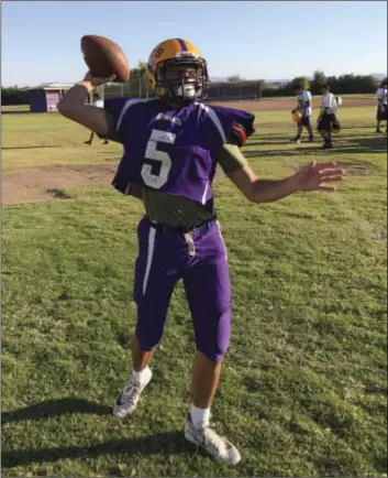  ??  ?? Southwest varsity quarterbac­k Cameron Jungers warms up for throwing a football. JONATHAN PUGA PHOTO practice by