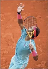  ?? Martin Bureau / Getty Images ?? At left, Serena Williams serves to Kristie Ahn. Rafael Nadal, right, serves during his match with Egor Gerasimov. Nadal and Williams both won in straight sets Monday.