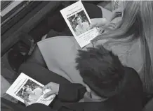  ?? Pool/Getty Images ?? Loved ones hold programs during the funeral mass for Brian Fraser at St. Paul on the Lake Catholic Church.