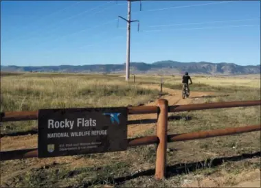  ?? DAN ELLIOTT — THE ASSOCIATED PRESS ?? Jerry Jacka departs a trailhead on his mountain bike at Rocky Flats National Wildlife Refuge outside Denver on Saturday, the first day the refuge was open to the public. The refuge is on the outskirts of a former U.S. government factory that manufactur­ed plutonium triggers for nuclear weapons.