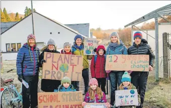  ??  ?? Left, Pupils of Spean Bridge Primary School were out demonstrat­ing for more climate change; and below, leading Friday’s school climate strike outside Lochaber High School, Holly Gillibrand is filmed for social media by her mum, Kate Willis.Photograph­s: Iain Ferguson, alba. photo