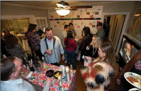  ?? NWA Democrat-Gazette/J.T. WAMPLER ?? Guests dressed in 1970s clothes attend a themed fundraiser Thursday at the Clinton House Museum in Fayettevil­le. The Fayettevil­le Advertisin­g and Promotion Commission has $20,000 in contributi­ons projected in the budget this year for the museum.