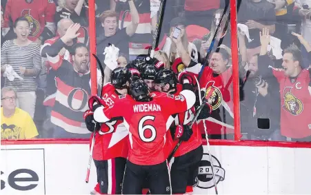  ??  ?? Senators fans and players celebrate Mike Hoffman’s goal in the first period in Ottawa on Wednesday. Besides Hoffman, that group hug includes Kyle Turris, Fredrik Claesson, Alex Burrows and Chris Wideman.