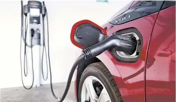  ?? RICHARD VOGEL/AP 2018 ?? As more electric vehicles become available, the U.S. is looking to increase the number of plugs to meet demand.