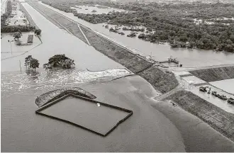  ?? Brett Coomer / Houston Chronicle ?? Water is released from the Addicks Reservoir in the aftermath of Tropical Storm Harvey.