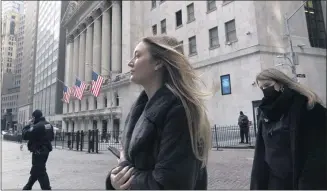  ?? MARK LENNIHAN – THE ASSOCIATED PRESS ?? In January, people walk by the New York Stock Exchange. Stocks are opening higher on Wall Street as traders welcome some strong reports on the economy including a drop in jobless claims and a big increase in retail spending, as well as more robust earnings from big companies including Citigroup and United Healthcare.