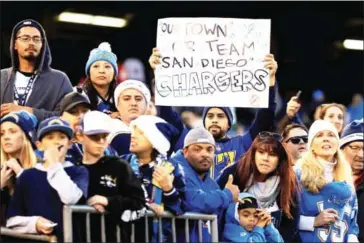  ?? SEAN M HAFFEY/GETTY IMAGES/AFP ?? San Diego Chargers fans look on during the second half of the game against the Kansas City Chiefs at Qualcomm Stadium in San Diego, California, on New Year’s Day.