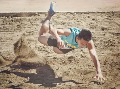  ?? SUNSTAR FOTO / ALEX BADAYOS ?? IMPROVISED. Oliver Alinganga’s training with an improvised landing pit for long jump pays off as he won the gold medal for Cebu Province.