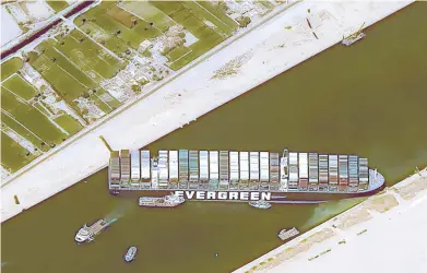  ?? CNES2021, DISTRIBUTI­ON AIRBUS DS ?? This satellite image shows the massive cargo ship Ever Given stuck Thursday in the Suez Canal. Now the business of determinin­g who will pay for clearing the vessel from the key shipping lane begins. The results may not be known for several years.