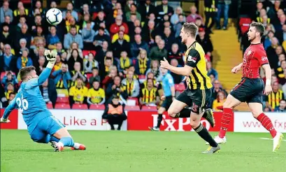  ?? REX ?? Rocketman: Shane Long (right) dinks over Ben Foster to for the record-breaking strike